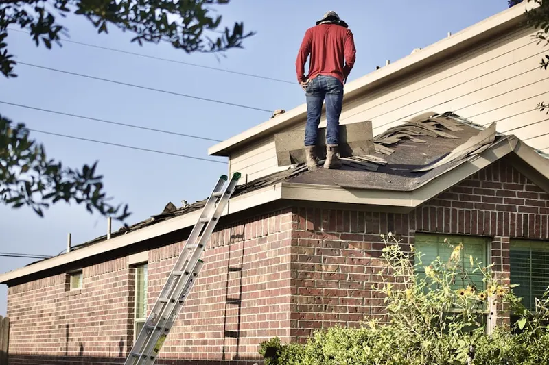 Professional roofer working on a residential roof in Eureka Springs